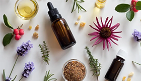 Random herbs and glass tincture bottles splayed out.